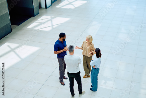 Obraz na płótnie Diverse business team collaborating and discussing ideas while standing in a mod