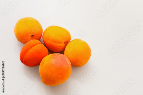 Canvas Print Fresh apricots placed on a plain surface ready for a snack or dessert in a kitch