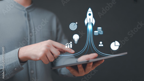 Businessman using tablet for digital growth Startup rocket launch icons Corporate strategy success.