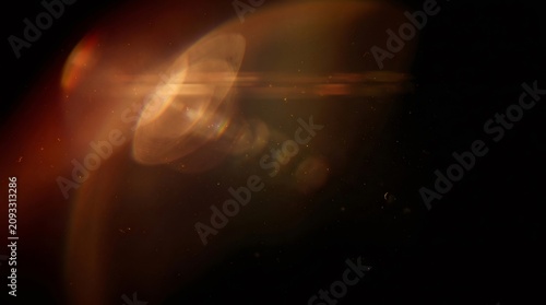 Golden anamorphic lens flare with dust particles overlay