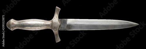 Bild auf Leinwand Ornate silver dagger displaying intricate metal engravings on its hilt while iso