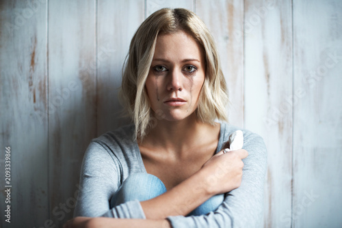 Foto Wooden wall, portrait and woman with tears, crying and sad with anxiety and frustrated after mistake