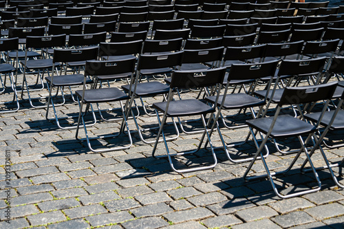 Chairs arranged for an event in a public space in Prague on a sunny day