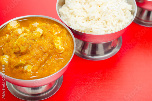 Golden curry sits beside steaming white rice