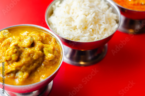 Golden curry sits beside steaming white rice