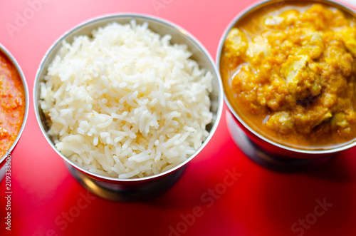 Golden curry sits beside steaming white rice