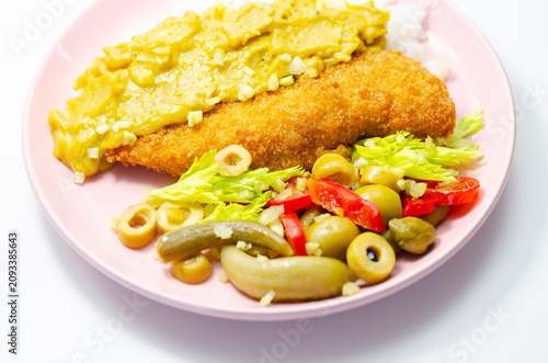 Golden-breaded fish rests on a pink plate