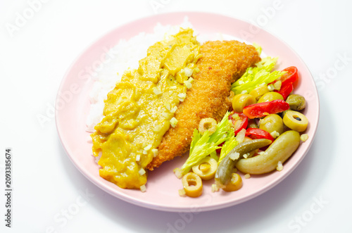 Golden-breaded fish rests on a pink plate