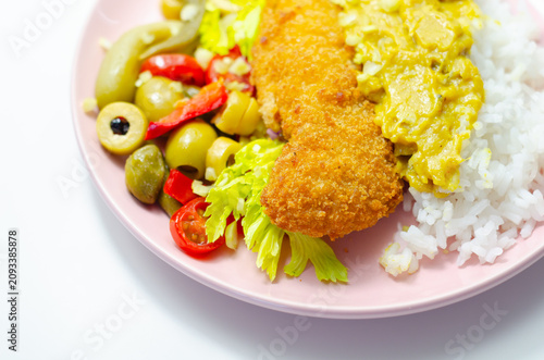 Golden-breaded fish rests on a pink plate