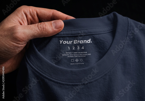 Close-up of a Hand Holding T-shirt Label Mockup