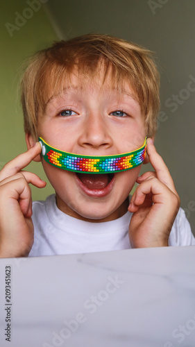 A boy holding a diamond mosaic bracelet craft close-up