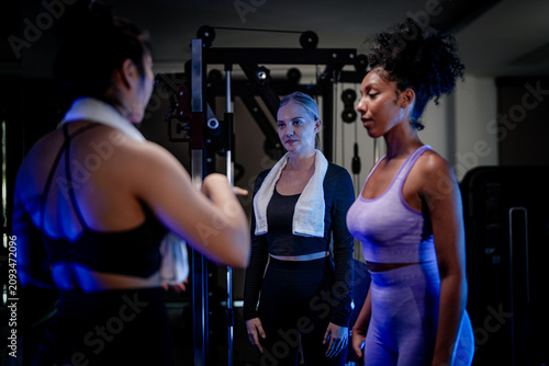 Картината върху платно Empowered women in the gym: an inclusive group of female athletes loosening up f