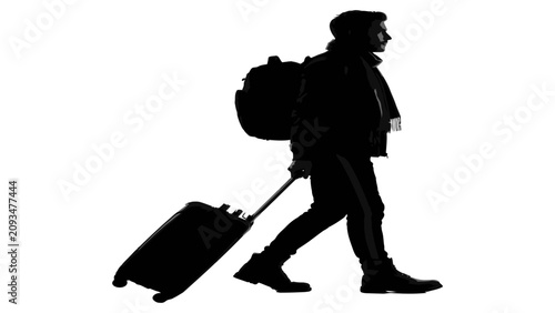 Obraz na plátně Traveler walks with a rolling suitcase and a backpack to represent the concept of a long journey