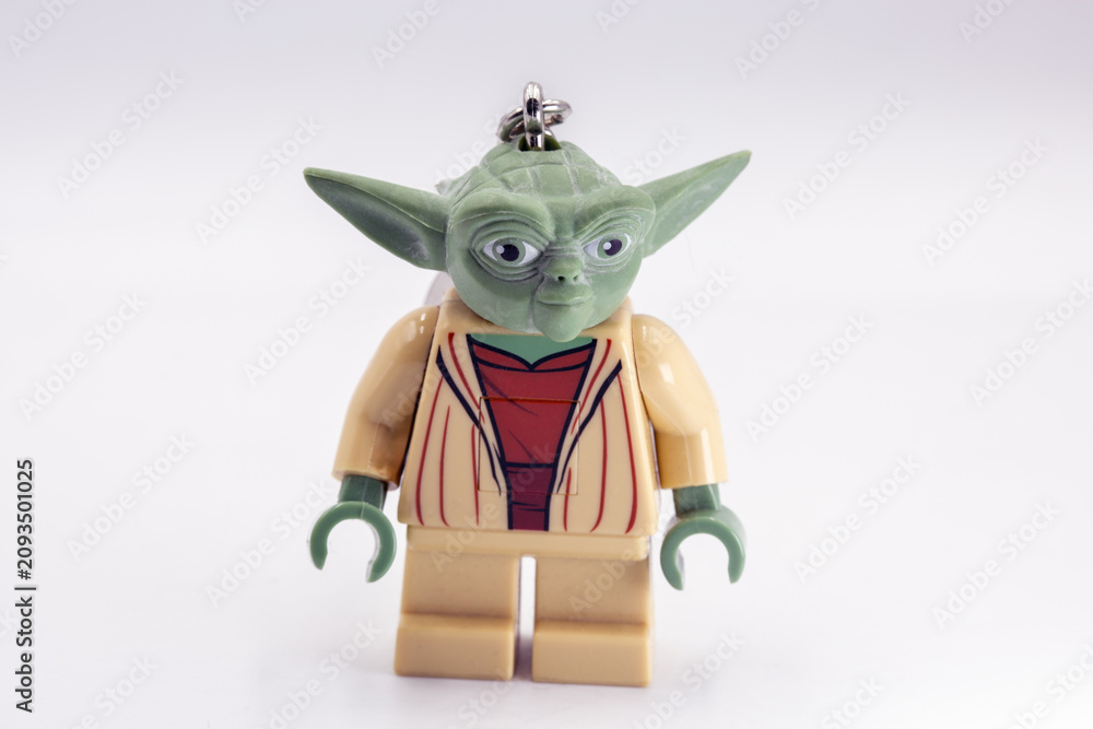 Fototapeta premium Yoda toy figure from Star Wars film closeup on white.
