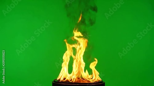 A bright orange flame burns steadily against a solid green background