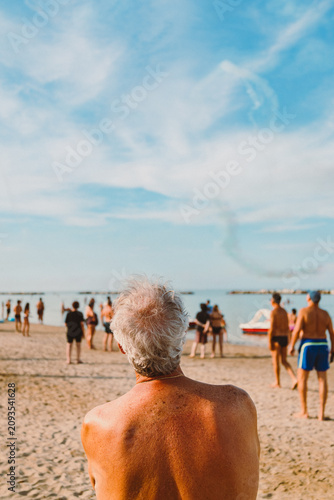 Atmospheric couple watching Frecce Tricolori from sandy beach at Igea Marina Italy.CR3