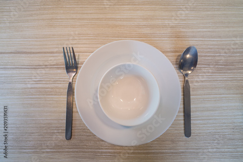 white dish and spoon on table