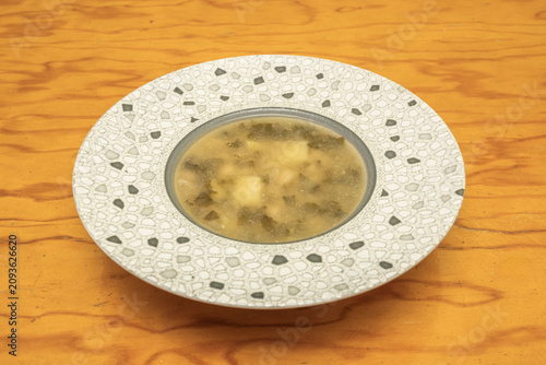 Miso Soup with Tofu and Wakame Seaweed Served in Decorative Mosaic Pattern Bowl on Wooden Table