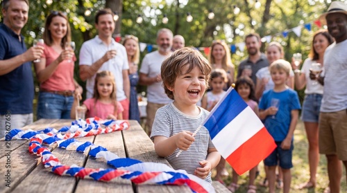 A French toddler laughs with a flag beside blue-white-red streamers at a Bastille Day friends gathering for stock photography