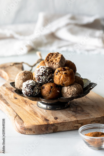 A pile of fresh homemade energy balls with a bite out of the one on top.