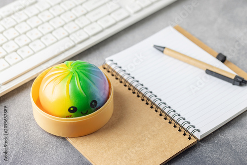 Cute pastel dumpling squishy toy held on the table. Trendy anti stress toy