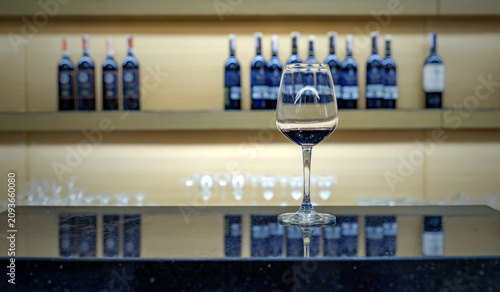 Bild auf Leinwand Elegant Red Wine Glass on Bar Counter