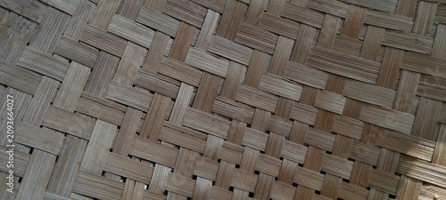 Traditional woven bamboo texture with a natural brown background.