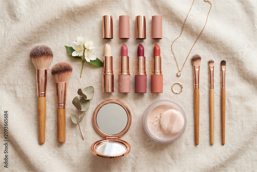 Beauty products flat lay with lipsticks and makeup brushes
