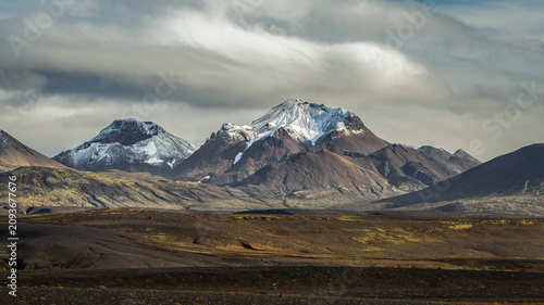 Snow capped volcanic mountains in the icelandic highlands