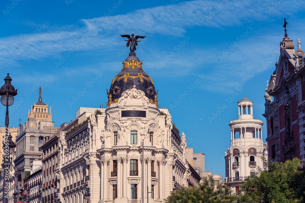 Fototapeta premium Panoramic view of the Metropolis Building with surrounding historic architecture on Gran Via in Madrid
