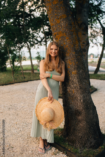 Woman smiling enjoying summer holiday with straw hat