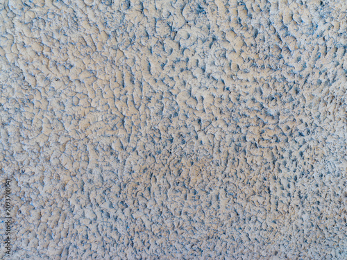 Bild auf Leinwand Close up macro texture of rough grey bumpy stucco wall surface outdoors