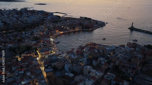 Aerial drone view of the Venetian harbor with its lighthouse breakwater and domed mosque, Chania, Greece