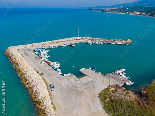 Small harbor with boats docked, aerial view.