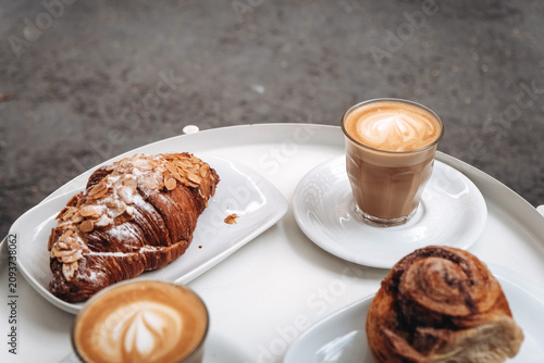 Delicious cups of coffee with puff croissants in a cozy cafe setting 