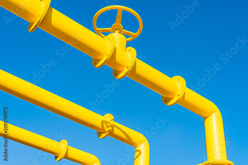 Photography Large industrial pipeline system, robust metal pipes with flanges and bolts, yel