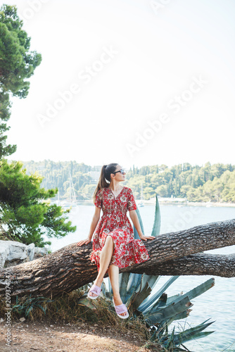 A woman reveling in the beauty of nature beside a serene and tranquil sea setting