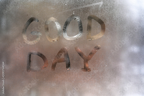 Картината върху платно Inscription Good Day is handwritten on fogged window glass with water drops