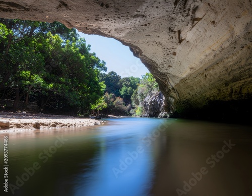 Serene river flowing through lush green valley.