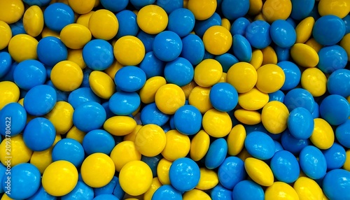 A vibrant mixture of blue and yellow candies densely packed