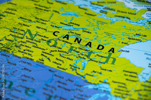 World map closeup with canada on focus. Wonderlust or tour or travel concept.