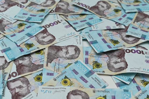 Ukrainian hryvnia banknotes cover surface completely. National cash currency symbolizes consumer inflation, macroeconomics crisis, central bank finance, investment capital.