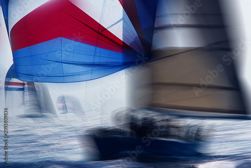 Photos Vintage 35mm film scan of sailboat regatta, colorful spinnaker and racing yachts on sparkling sea,  intentional motion blur, abstract sport background