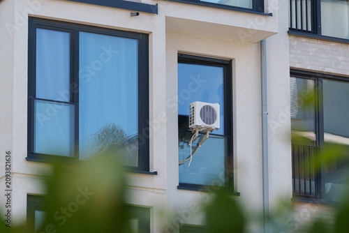 Window mounted air conditioner cools apartment during Europe's summer heatwave