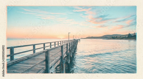 Serene Wooden Pier Extending into the Ocean at Sunset.