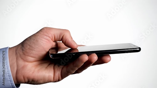 Male hand holding slim smartphone against white background.