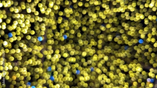 Horizontal 4K video. 60 fps. Blurred background with yellow and blue bokeh lights. Social media template. Copy space. Concept of Merry Christmas, Happy New Year 2027, congratulations, winter holiday