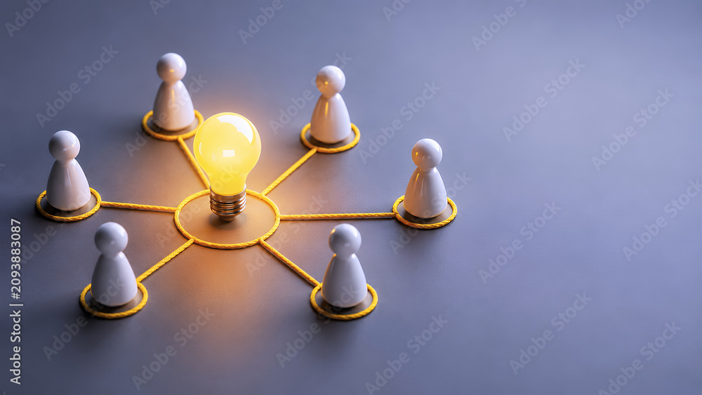 Obraz premium Connected people surrounding a glowing light bulb, knowledge sharing and team collaboration concept with copy space