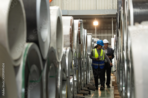 Fotografía Professional logistics team auditing metal coil storage facility or checking inventory in warehouse