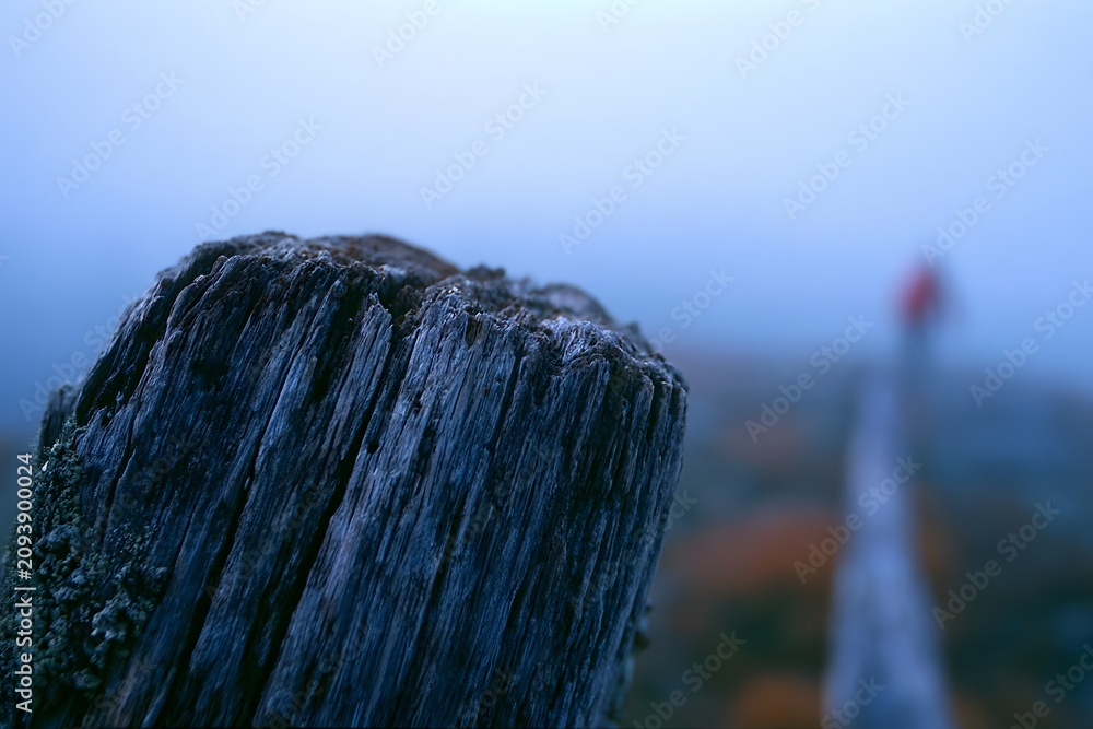 Fototapeta premium Rustic wooden post with blurred blue hour valley backdrop